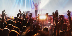 Musician receives applause from large audience at the end of a concert