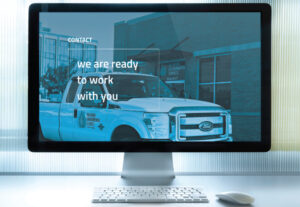 OES Contact page displayed on iMac monitor