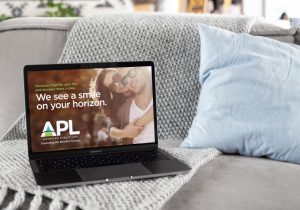 APL Logo on laptop screen design by Hester Designs