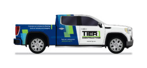 Tier 1 Roofing vehicle wrap divided with blue, white, and green truck showcasing company logo and contact information.