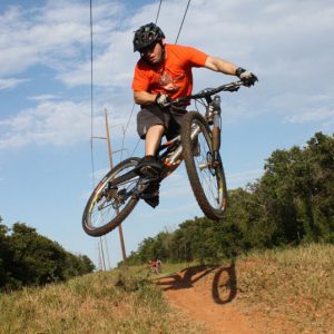 Jeff Hester jumps his mountain bike at Draper Lake trails in Oklahoma