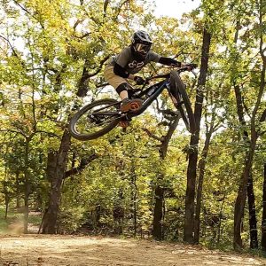 Jeff hits a jump on his mountain bike at Tulsa's Turkey Mountain trails.