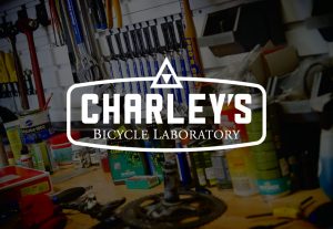 decorative background with charley's bicycle laboratory logo foregound