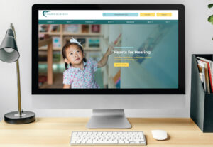 hearts for hearing homepage displayed on iMac screen