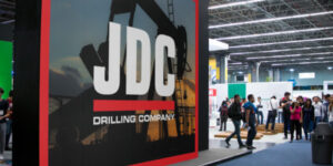 A large print banner displays at a trade show for the energy sector.