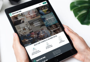 quail creek bank personal accounts page displayed on tablet screen being held