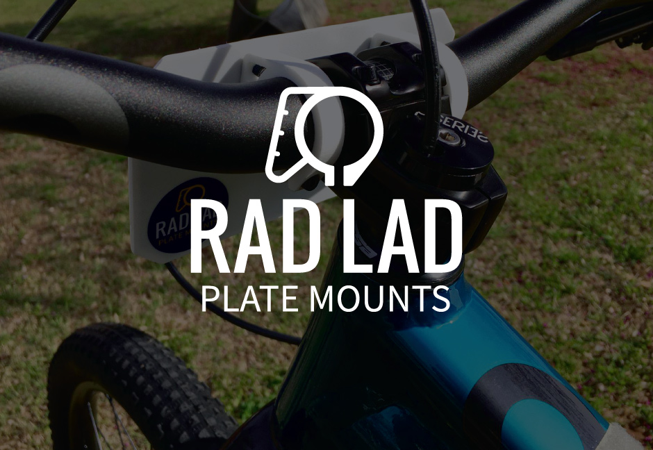 Rad Lad Plate Mounts Logo over darkened photo of a bicycle handlebar with plate mounts installed