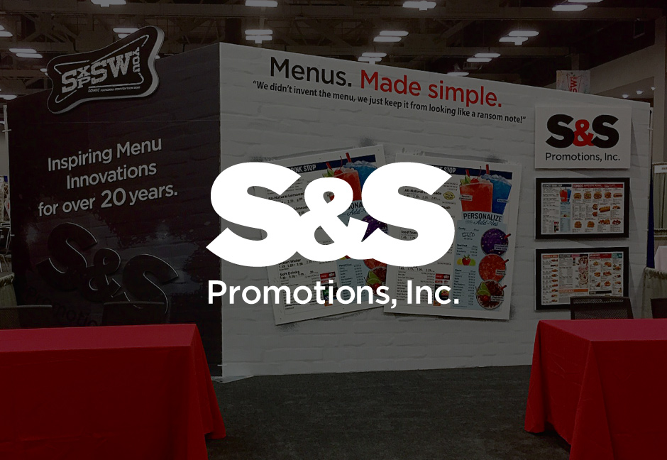 S&S Promotions Logo over darkened photo of trade show booth designed by Hester Designs