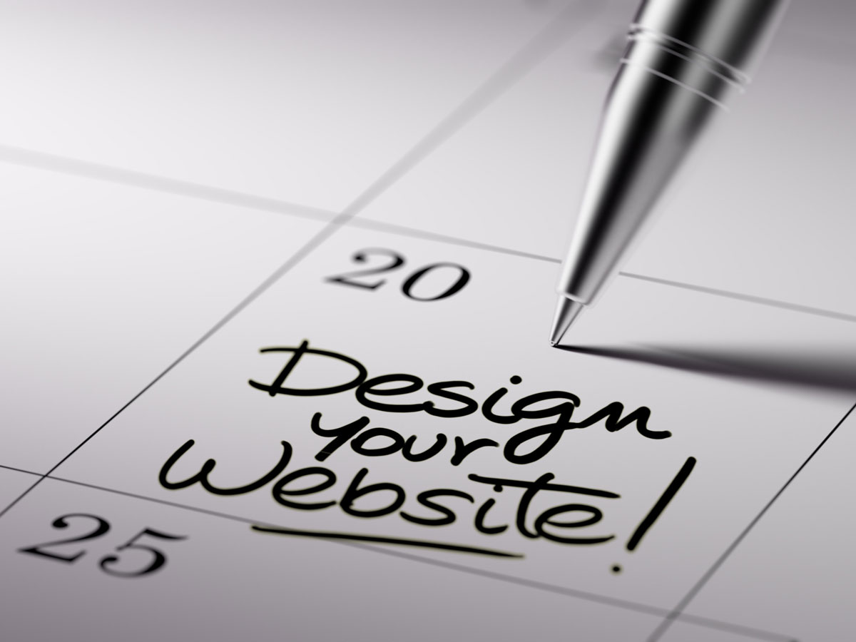 A pen is pointing to a calendar date with the words Design your Website written