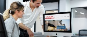 Westgate Marketplace website displayed on desktop computer being used by male and female coworkers