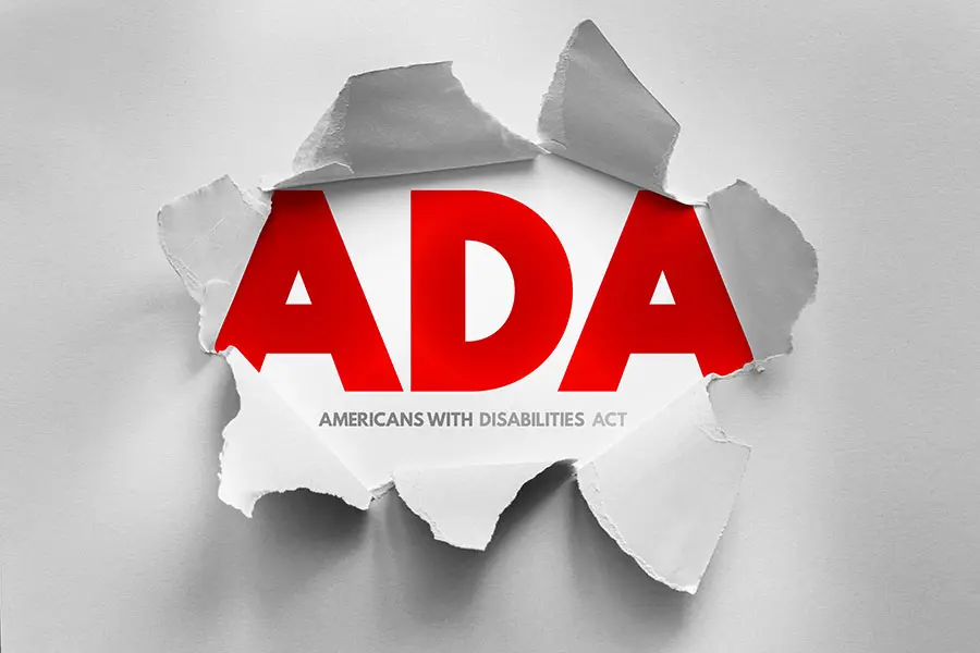 Red lettering that says ADA is ripping out of a paper background with lettering below American Disabilities Act.