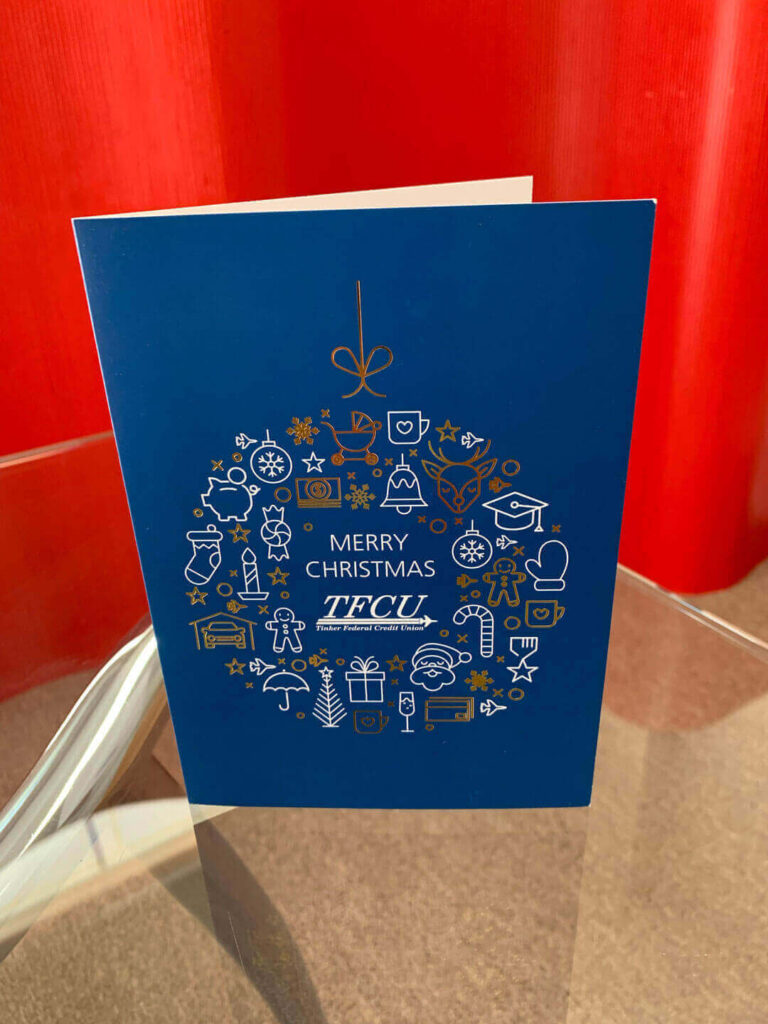 TFCU holiday card is blue with foil stamped elements.
